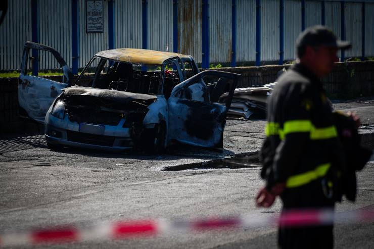 Un uomo morto fuori dall'auto in fiamme