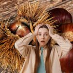 Sullo sfondo delle castagne e dei ricci di castagna ed una persona in primo piano preoccupata
