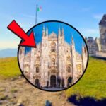 sfondo sculture in pietra e tondo con Duomo di Milano e freccia